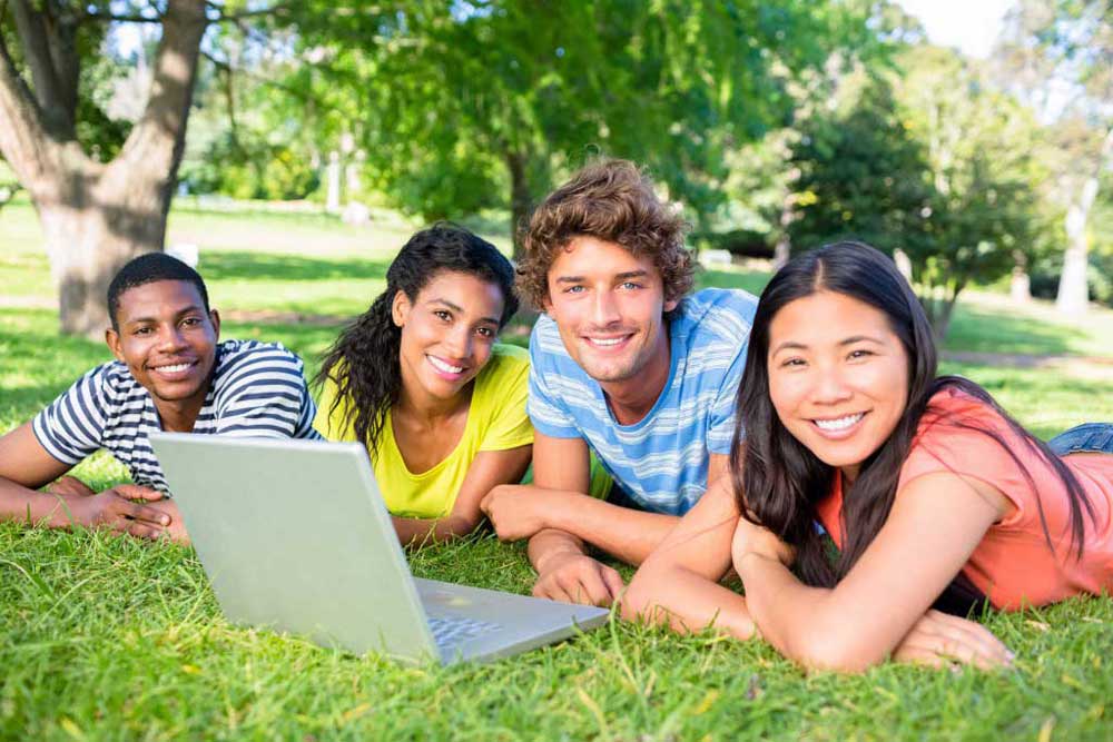 campus students on the grass